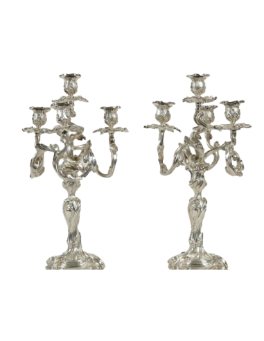 A Pair of silvered candlesticks in...