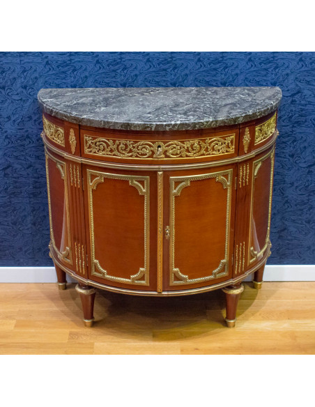 A Louis XVI style demi-lune commode. 19th century.