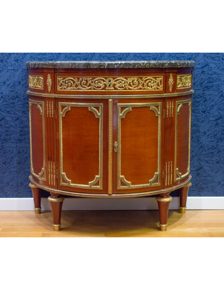 A Louis XVI style demi-lune commode. 19th century.