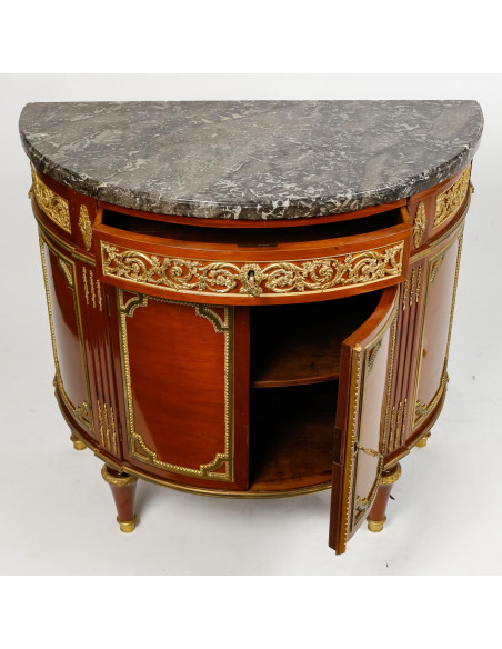 A Louis XVI style demi-lune commode. 19th century.