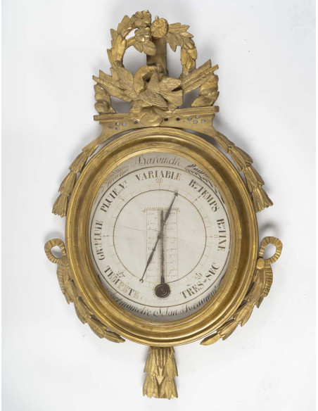 Baromètre en bois sculpté selon Scoly, d'époque Louis XVI (1774-1793). XVIIIème siècle.
