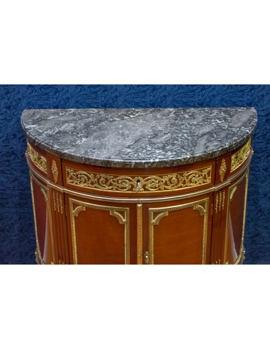 A Louis XVI style demi-lune commode....