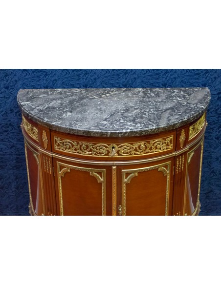 A Louis XVI style demi-lune commode. 19th century.